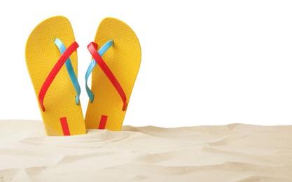 Photo of Yellow flip flops in sand on white background