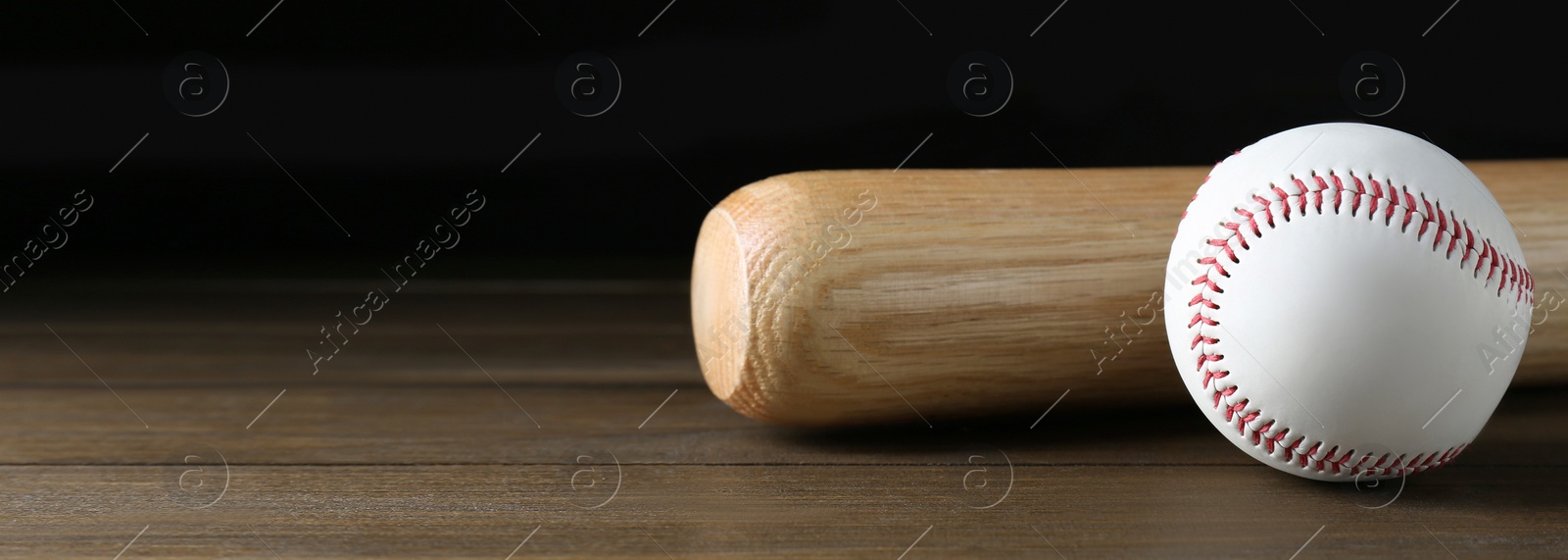 Image of Baseball bat and ball on wooden table, space for text. Banner design