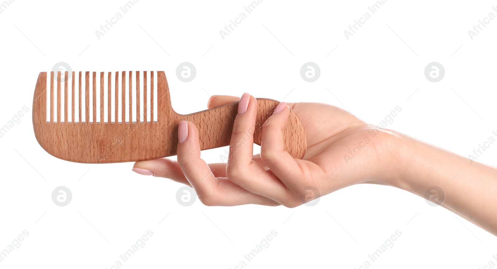 Photo of Woman holding wooden hair comb against white background, closeup