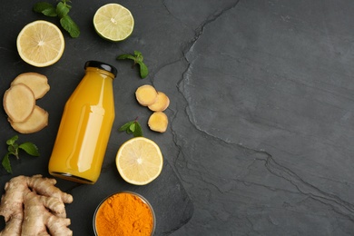 Flat lay composition with immunity boosting drink and ingredients on dark table. Space for text