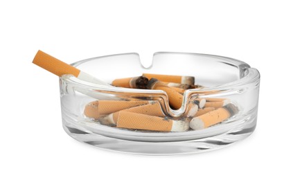 Photo of Glass ashtray with cigarette stubs isolated on white