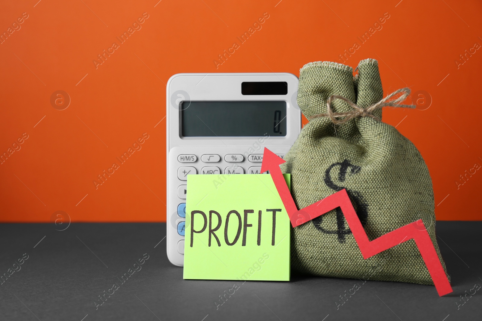 Photo of Economic profit. Money bag, calculator, note and arrow on grey table against orange background, space for text