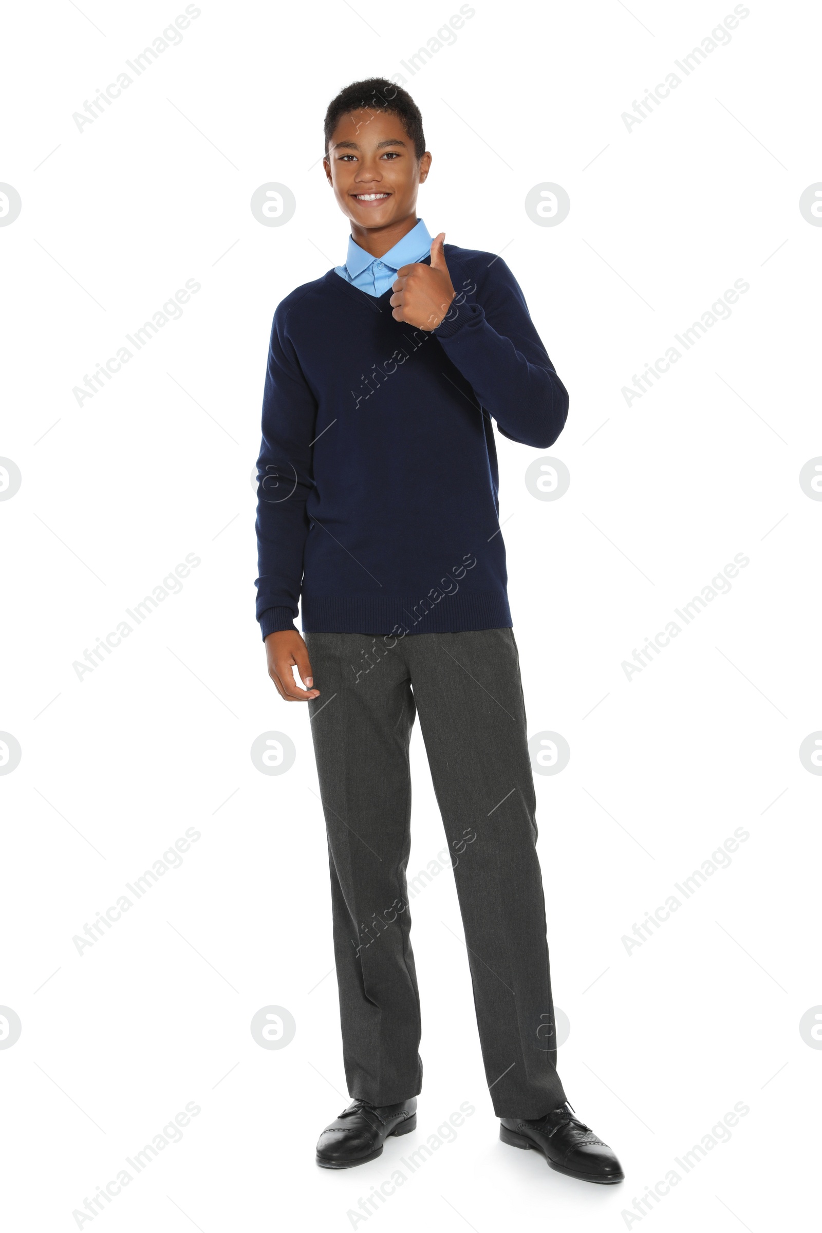 Photo of African American teenage boy in stylish school uniform on white background