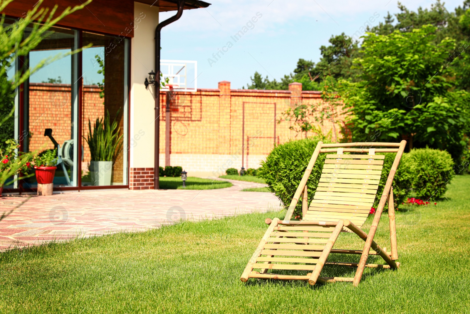 Photo of Wooden deck chair in beautiful garden on sunny day