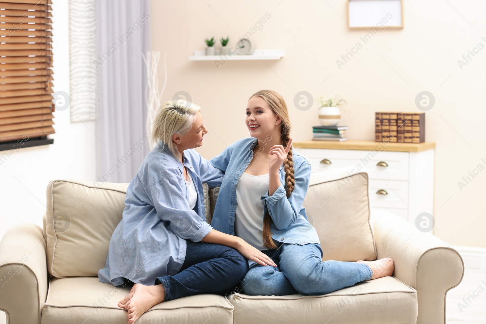 Photo of Mother and her adult daughter spending time together at home