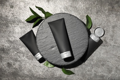 Photo of Set of men's cosmetic products on grey table, flat lay
