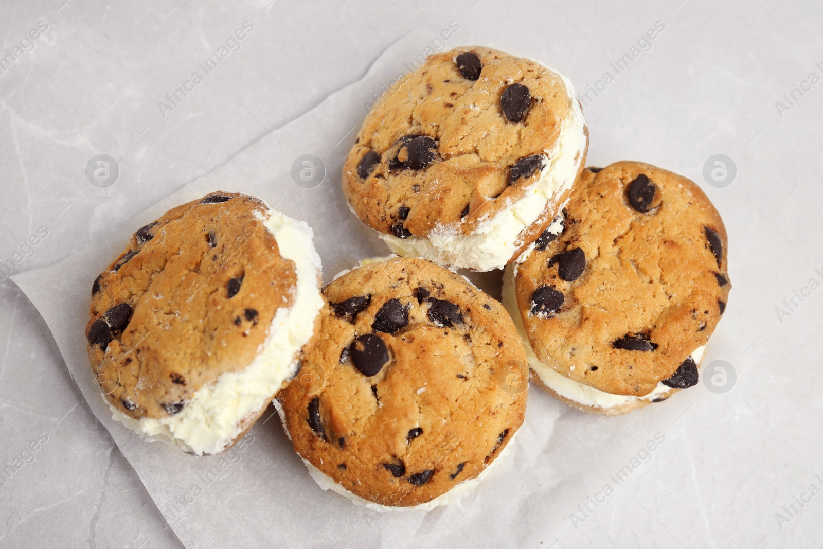 Photo of Sweet delicious ice cream cookie sandwiches on table, above view