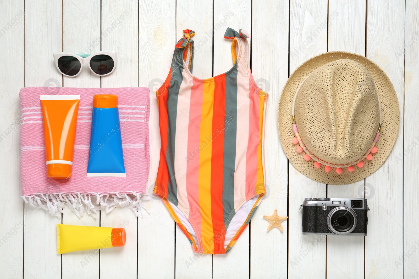 Photo of Different beach objects on white wooden background, flat lay