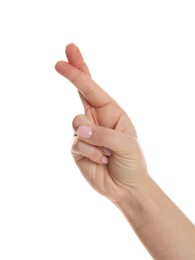Photo of Woman holding fingers crossed on white background, closeup. Superstition for good luck