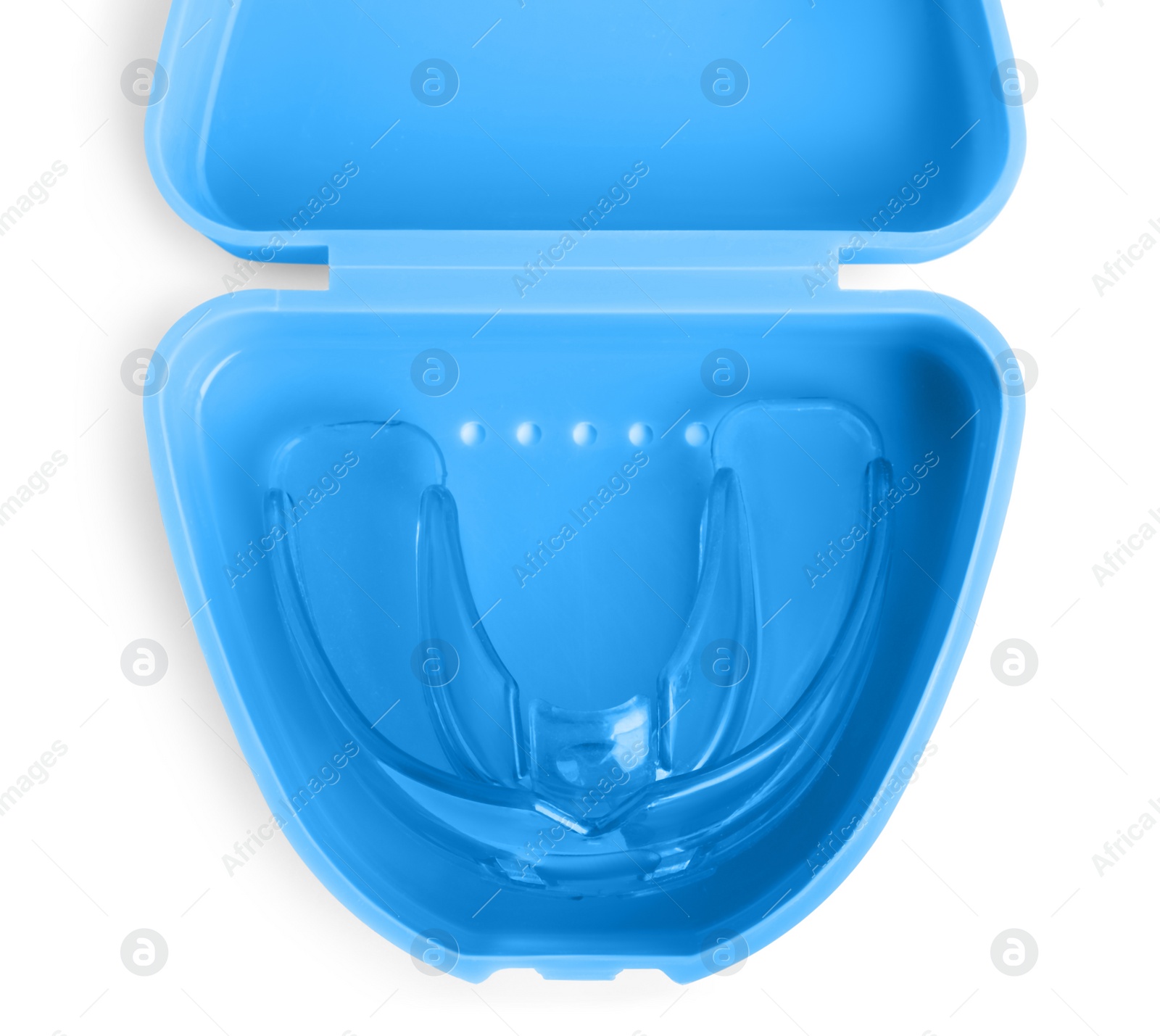 Photo of Transparent dental mouth guard in container isolated on white, top view. Bite correction