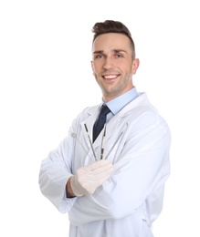 Photo of Male dentist holding professional tools on white background