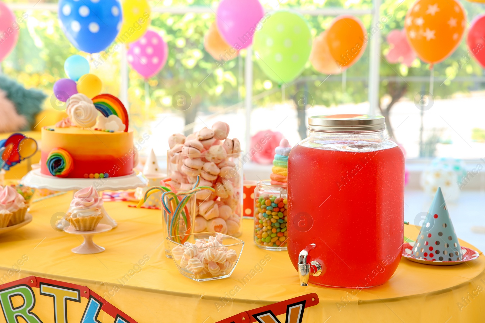 Photo of Table with birthday cake and delicious treats indoors