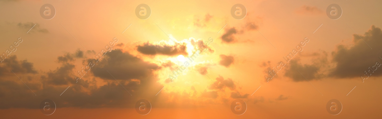 Image of Sun shining through clouds on beautiful sky, banner design