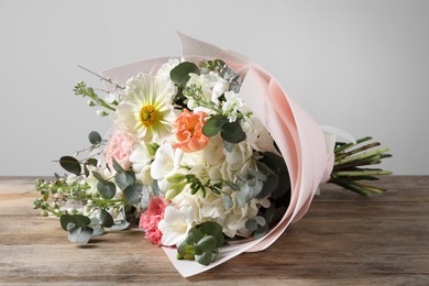 Photo of Bouquet of beautiful flowers on wooden table