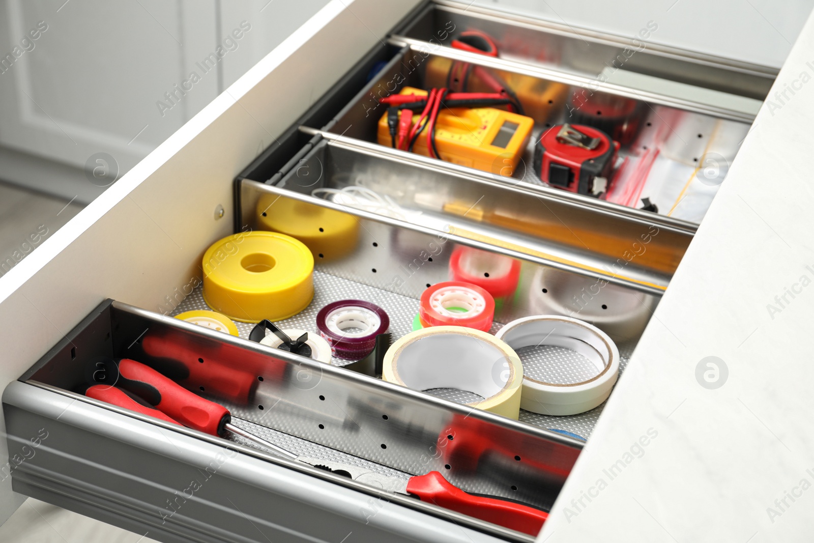 Photo of Set of instruments in open desk drawer indoors