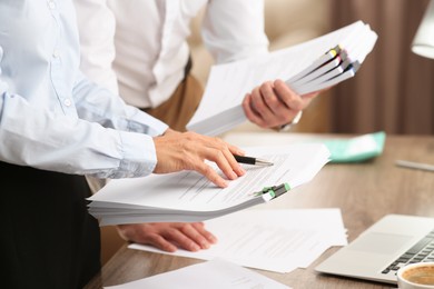 Photo of Businesspeople working with documents in office, closeup