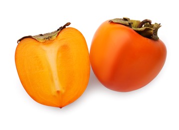 Photo of Whole and cut delicious ripe juicy persimmons on white background, top view