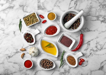 Flat lay composition with different aromatic spices on marble background