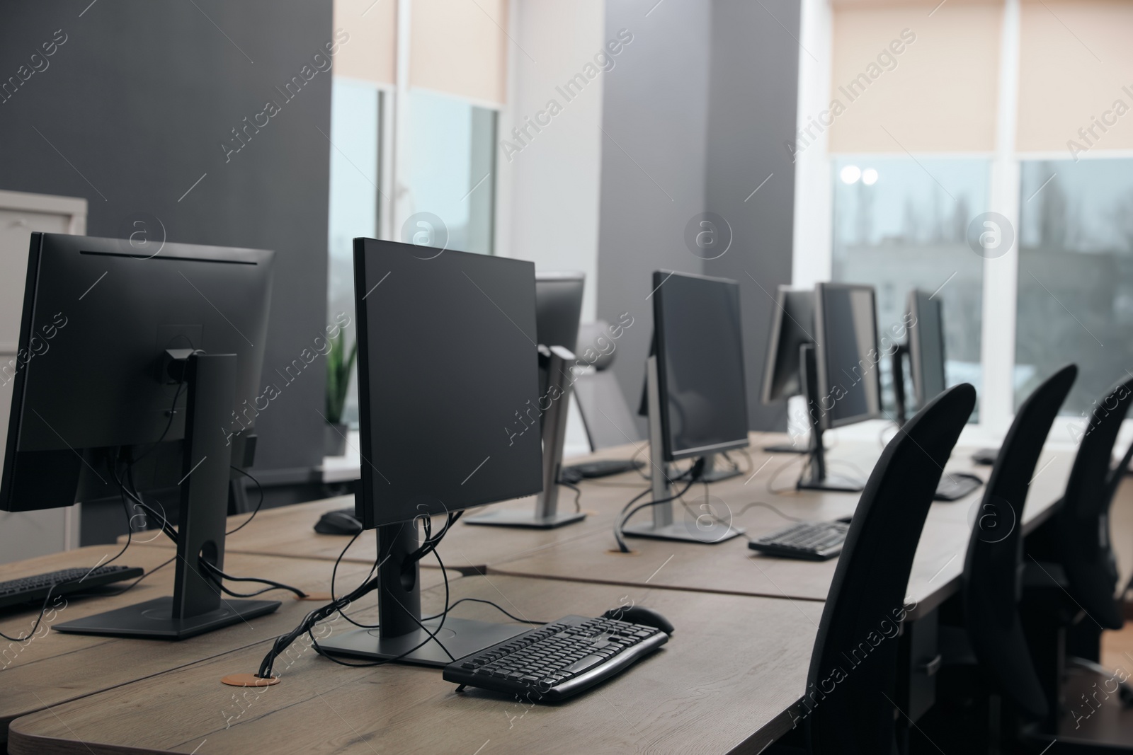 Photo of Many modern computers in open space office