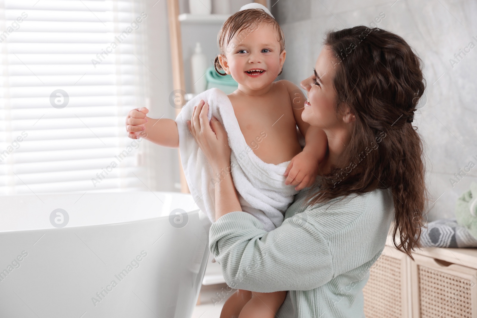 Photo of Mother with her little daughter in bathroom