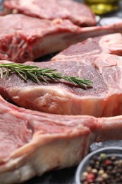 Photo of Fresh raw beef cuts and different spices on table, closeup