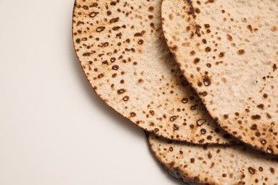 Tasty matzos on white background, top view. Passover (Pesach) celebration