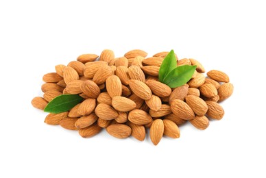 Photo of Pile of almond nuts and green leaves on white background. Healthy snack