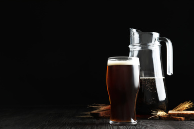 Delicious kvass, bread and spikes on wooden table. Space for text