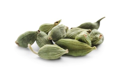 Photo of Pile of dry green cardamom pods on white background