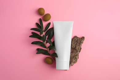 Photo of Natural cosmetic. Flat lay composition with olive cream on pink background