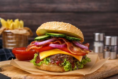 Photo of Tasty burger with bacon, vegetables and patty on wooden board, closeup