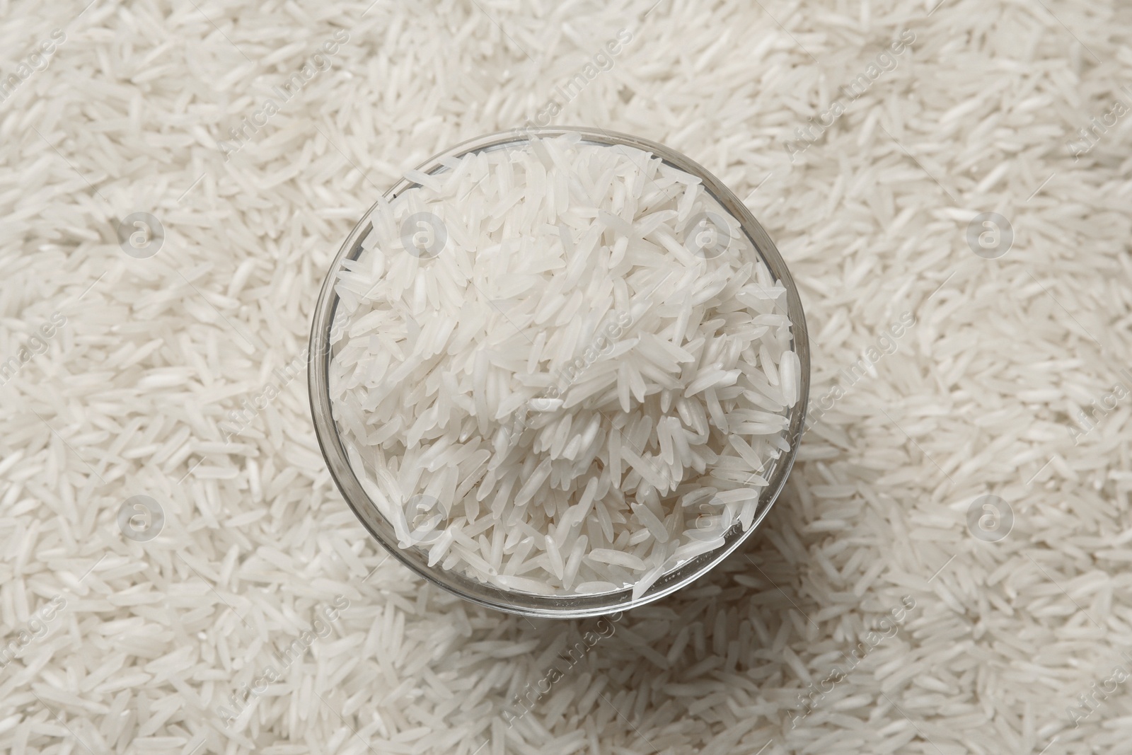 Photo of Raw basmati rice and bowl, top view