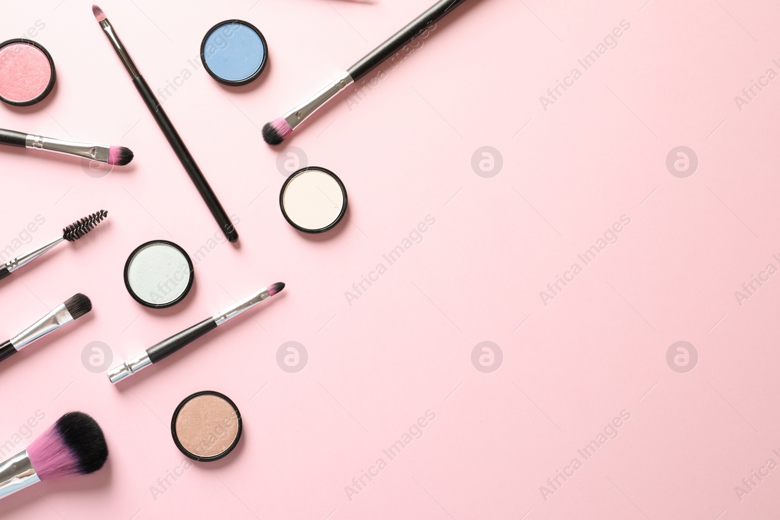 Photo of Flat lay composition with products for decorative makeup on pastel pink background