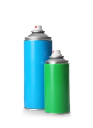 Photo of Different cans of spray paints on white background