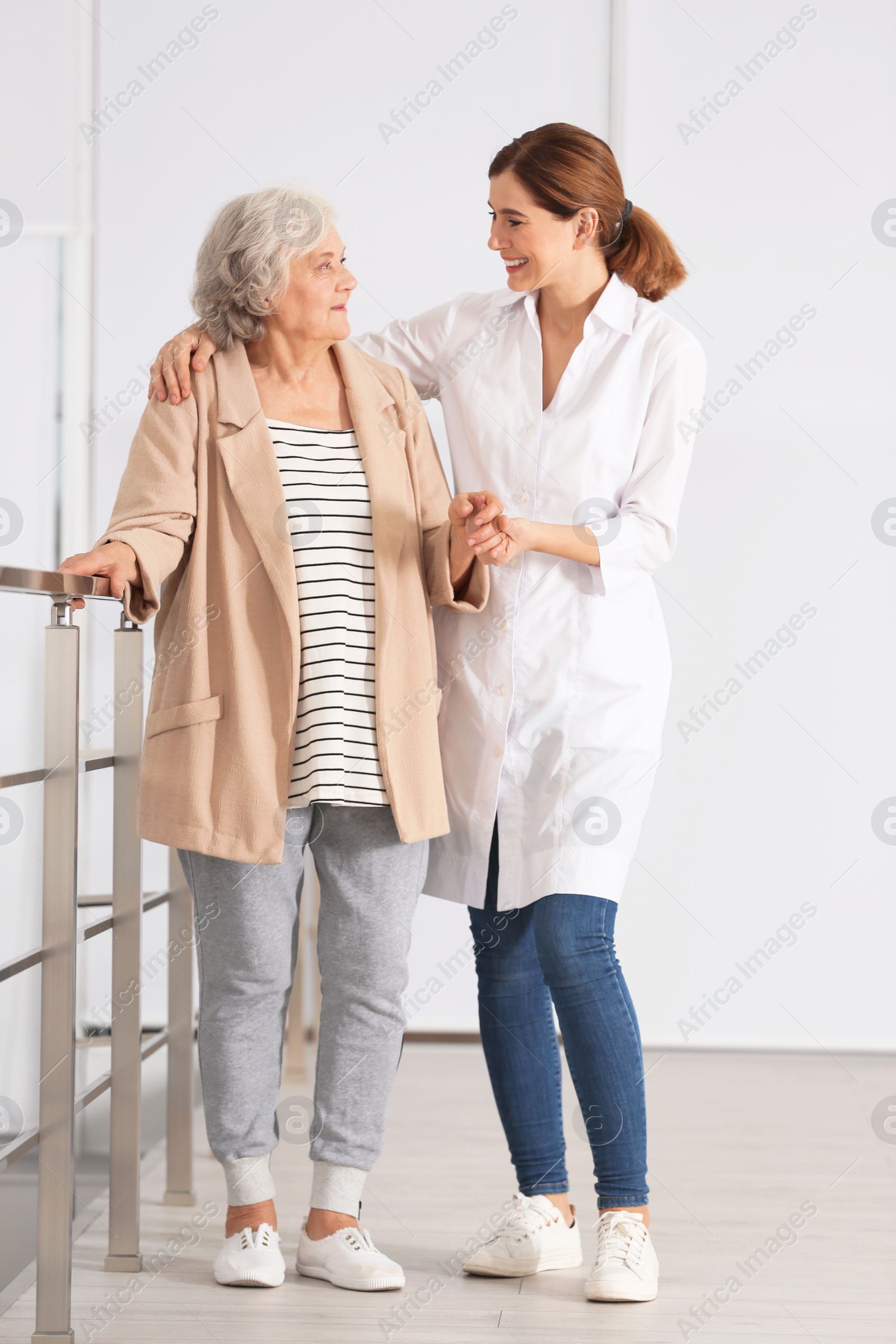 Photo of Elderly woman with female caregiver in room