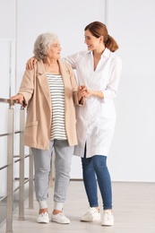 Elderly woman with female caregiver in room