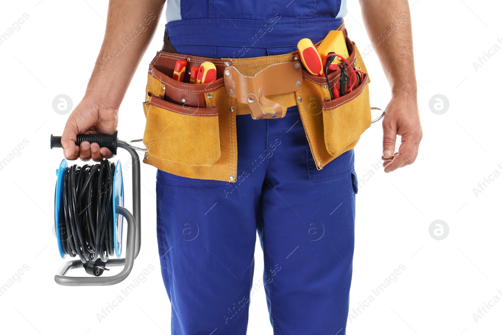 Photo of Electrician with extension cord reel and tools wearing uniform on white background, closeup