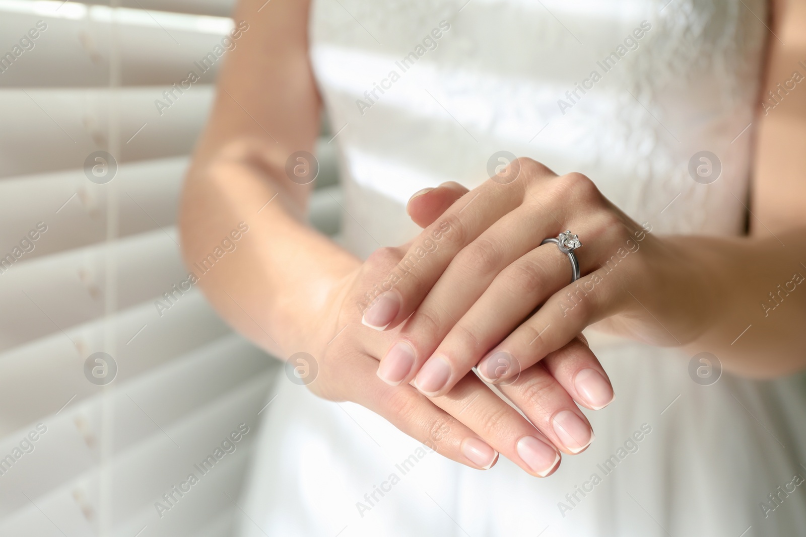 Photo of Young bride wearing beautiful engagement ring, closeup