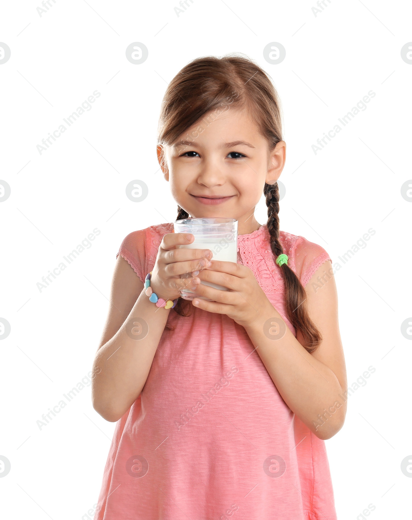 Photo of Cute little girl drinking milk on white background