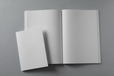 Photo of Blank brochures on light grey background, flat lay