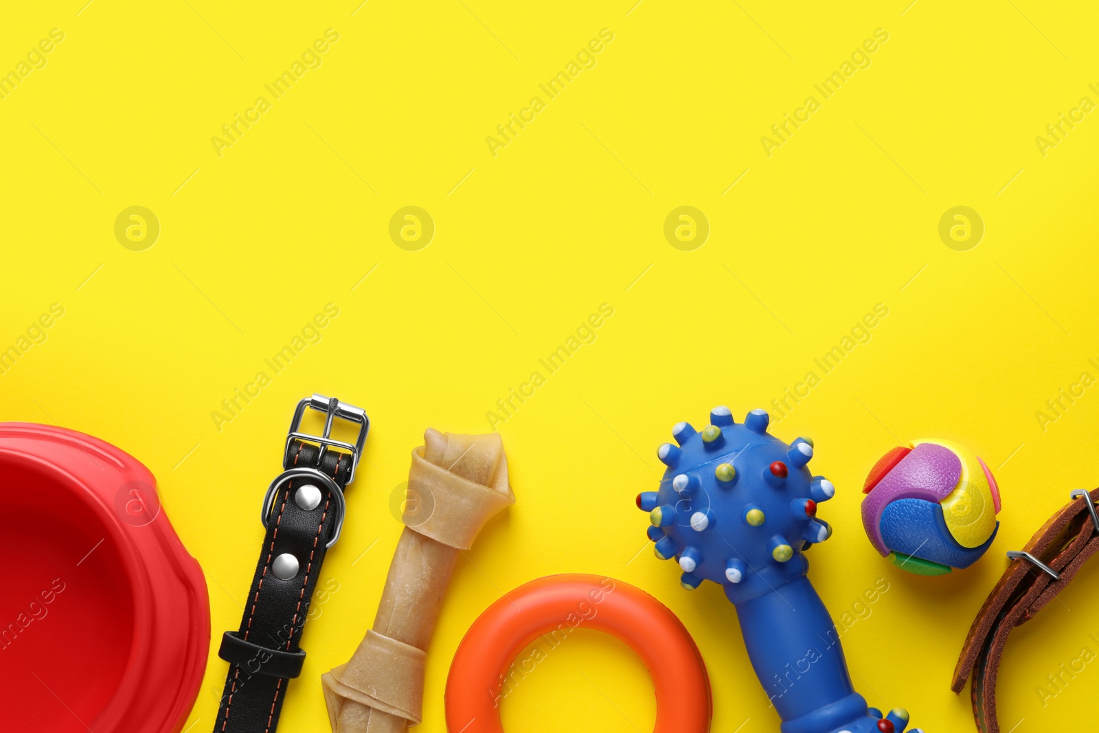 Photo of Flat lay composition with dog collars and different accessories on yellow background, space for text