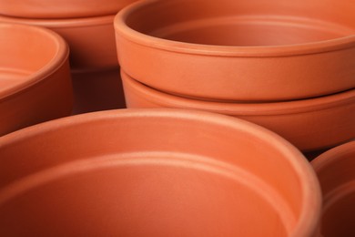 Photo of Many clay flower pots as background, closeup