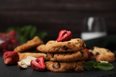 Photo of Cookies with freeze dried fruits, mint and nuts on grey table, closeup. Space for text