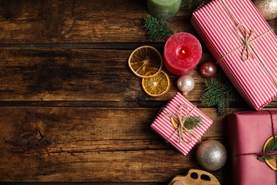 Photo of Flat lay composition with beautifully wrapped gift boxes on wooden table, space for text