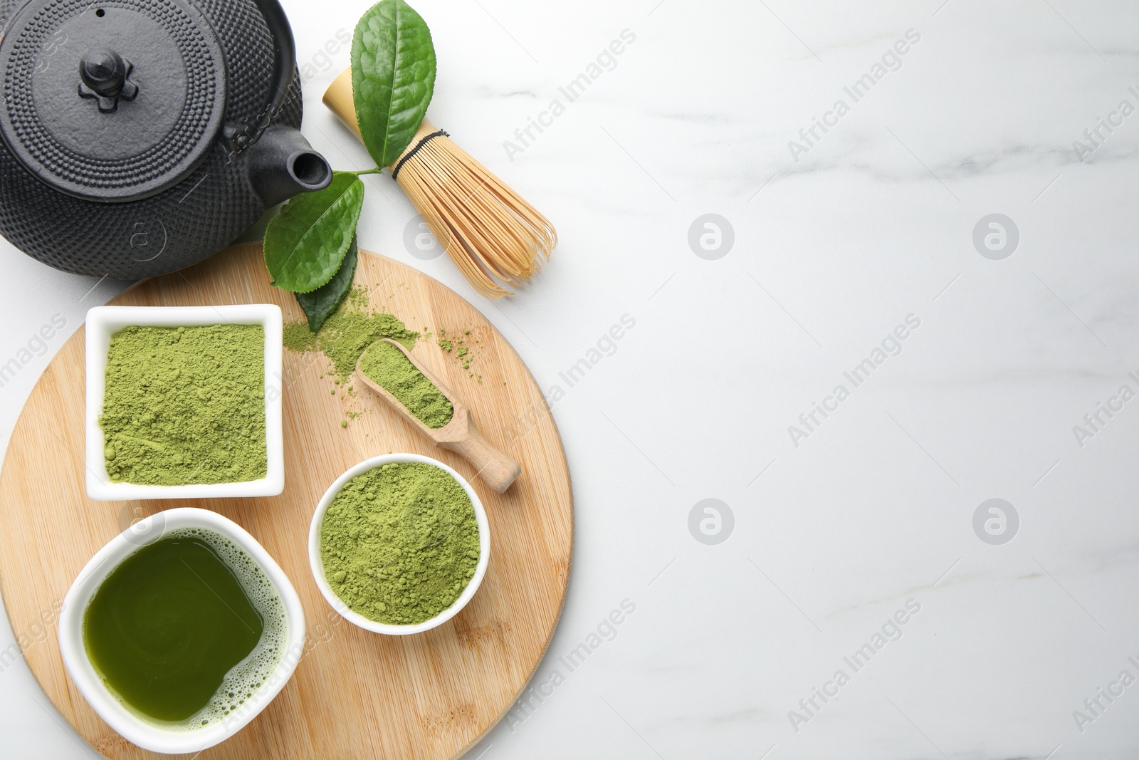 Photo of Flat lay composition with green matcha powder on white marble table, space for text