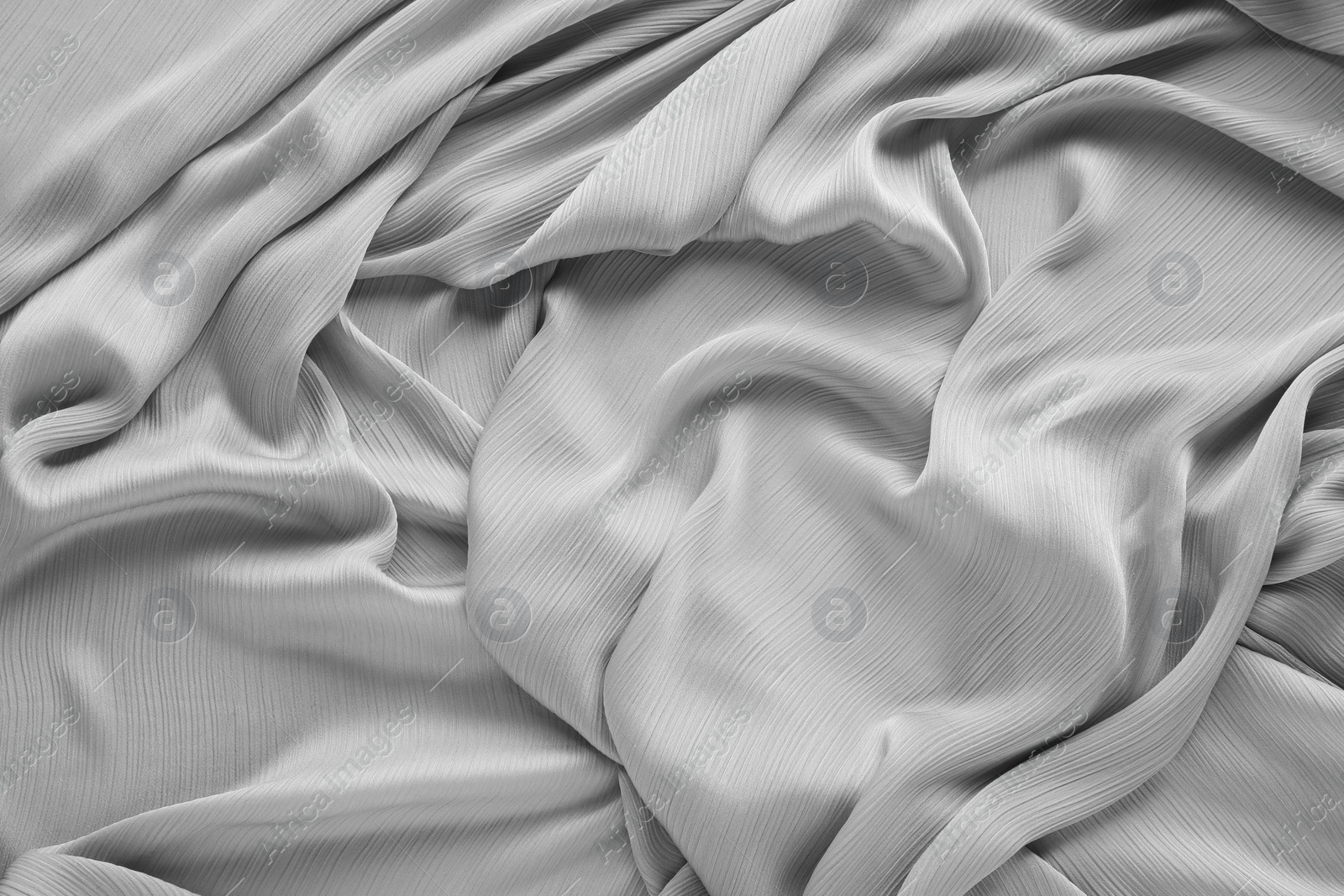 Photo of Beautiful grey tulle fabric as background, top view