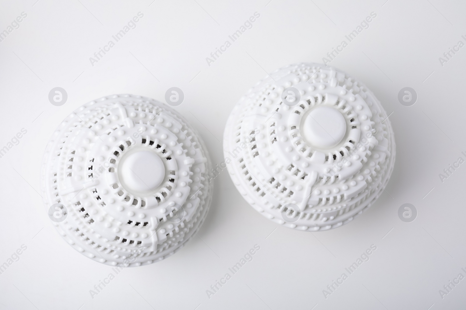 Photo of Dryer balls for washing machine on white table, flat lay