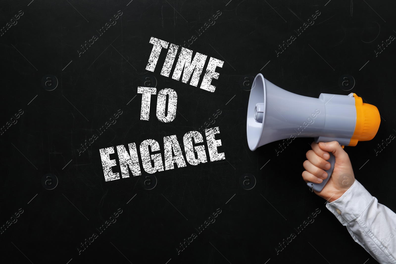Image of Man holding megaphone near chalkboard with text Time To Engage
