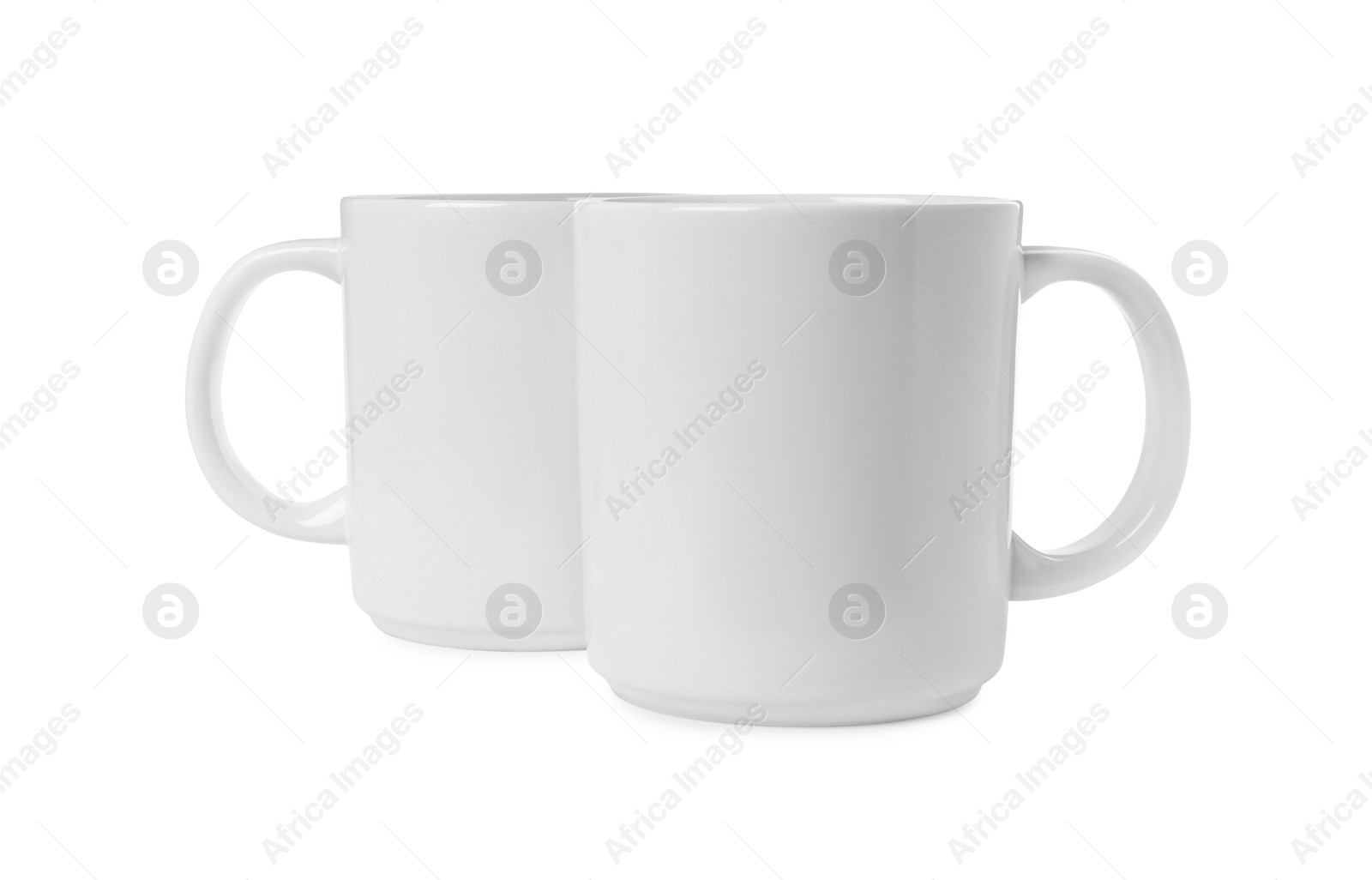 Photo of Two light ceramic mugs isolated on white