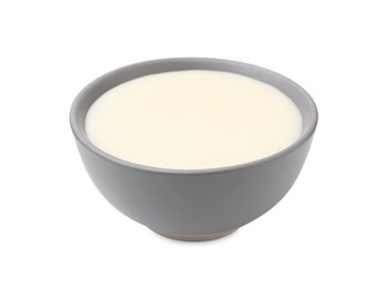 Photo of Bowl with condensed milk isolated on white